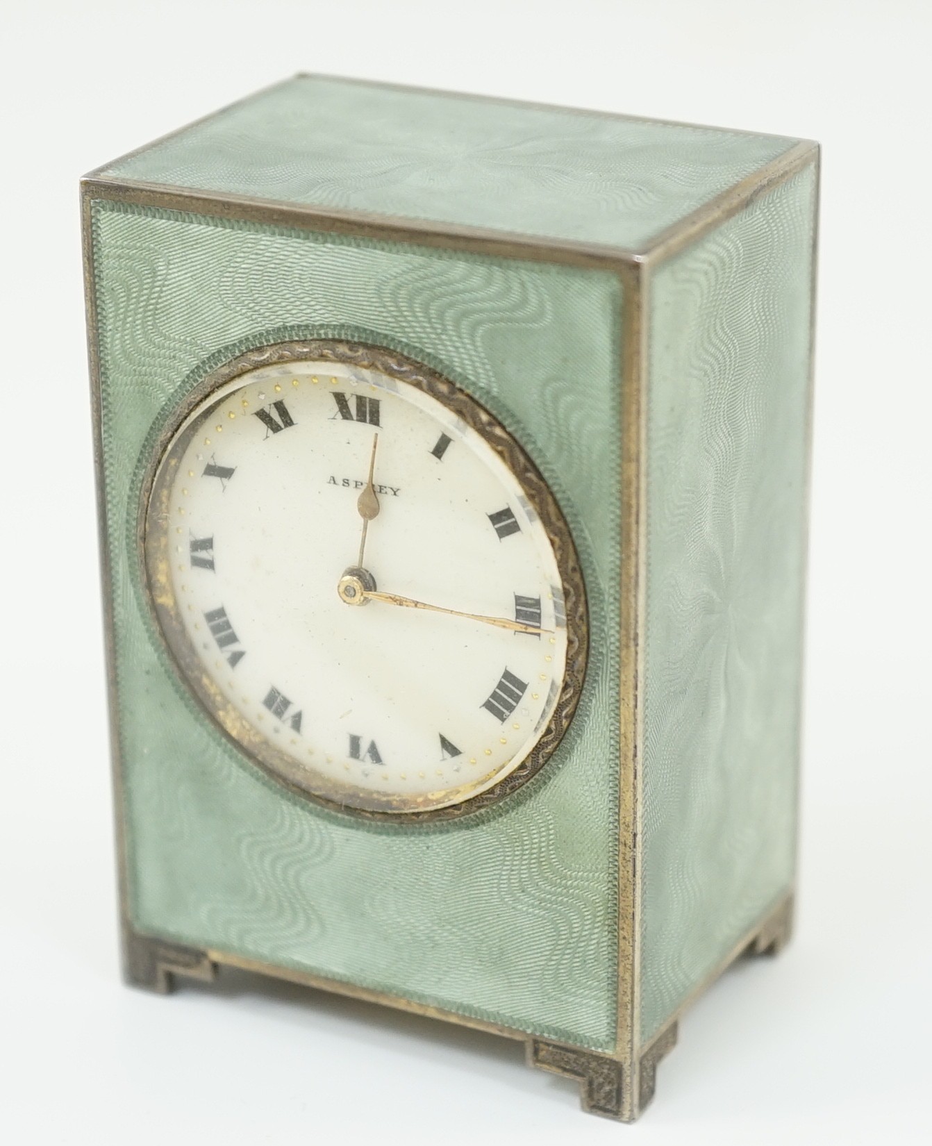 A George V silver and green guilloche enamelled travelling timepiece, retailed by Asprey, in original case